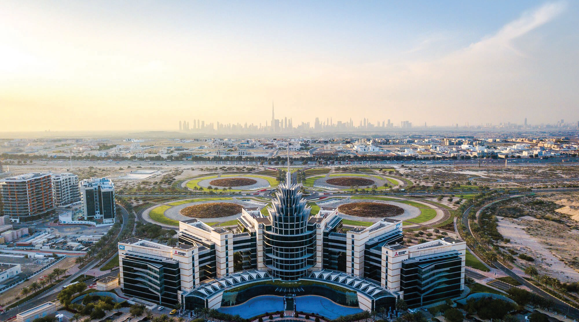 Aerial view of Dubai Silicon Oasis headquarters and technology park with the Dubai skyline behind