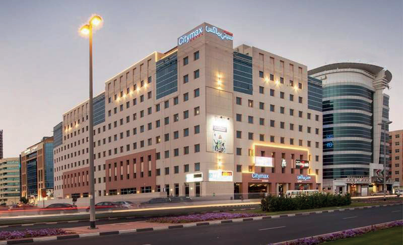 Citymax Hotel exterior at dusk with illuminated signage on the building