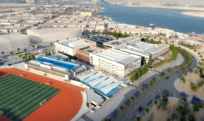 Aerial view of the Swiss International Scientific School Dubai campus with sports track, pool and academic buildings