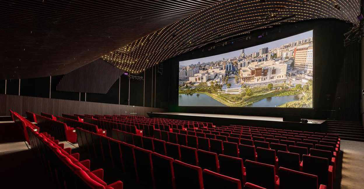 Empty festival screening theatre in Jeddah with tiered red seating and a wide screen