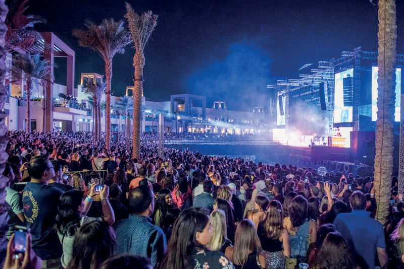 Packed night-time crowd at an outdoor concert at The Pointe, Palm Jumeirah
