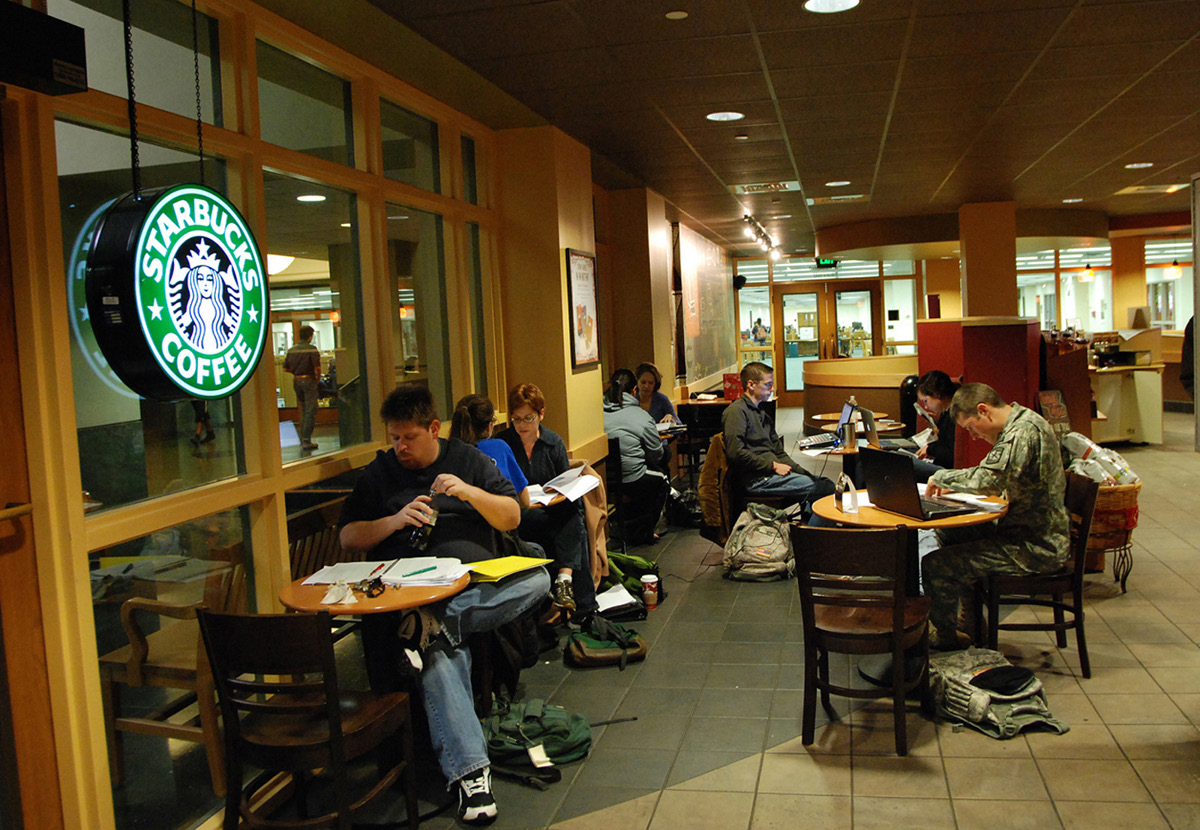 Customers working on laptops in a Starbucks seating area