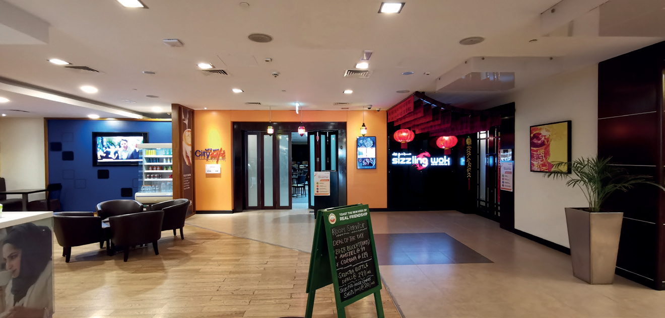 Citymax hotel lobby with café seating and restaurant entrances