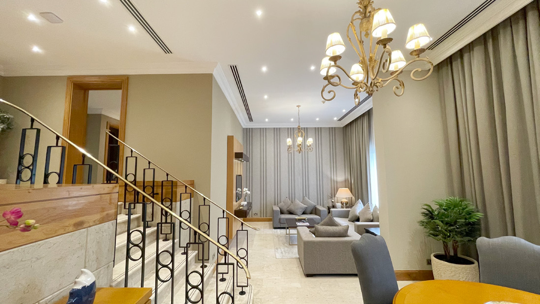 Villa interior at Dubai Marine Beach Resort with living area and staircase